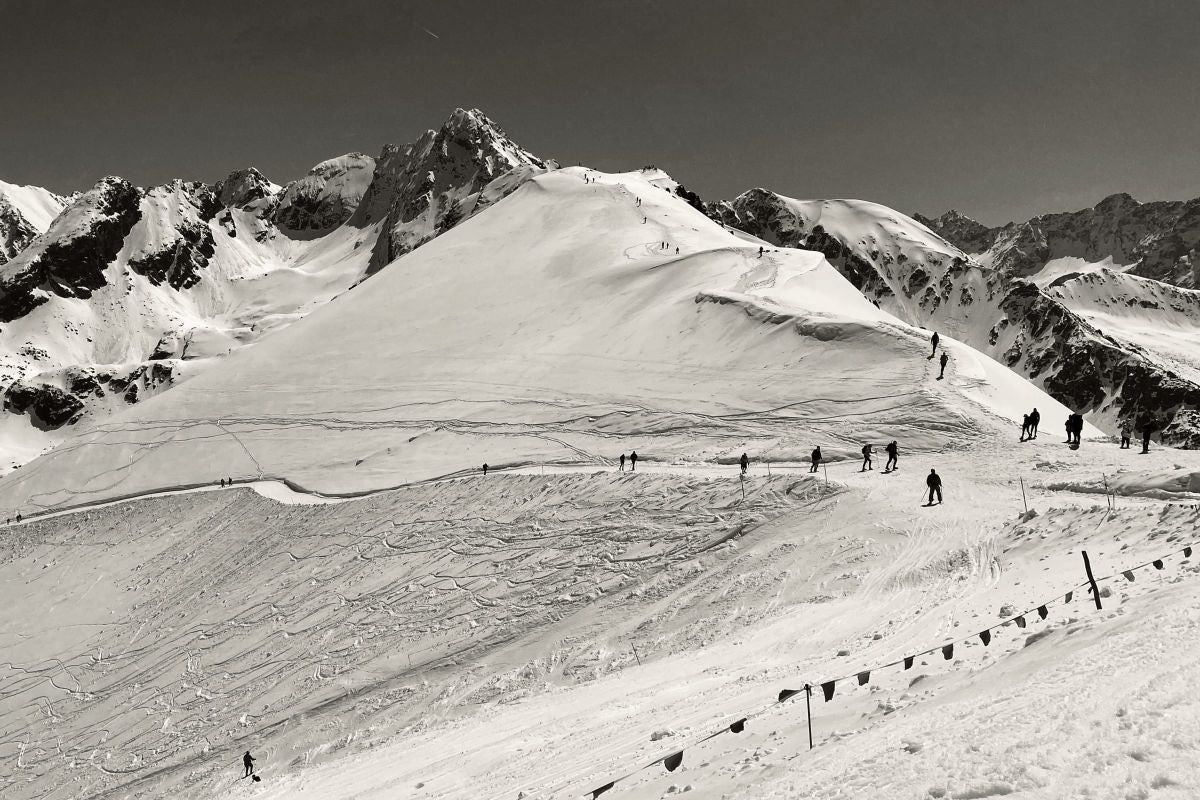 Skiers On A High-Altitude Ski Slope